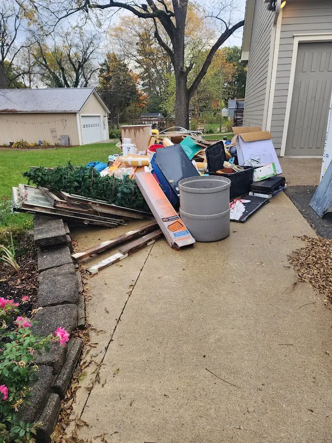 Dumpster being loaded with debris for Estate Cleanout Dumpster Rental in Colleyville
